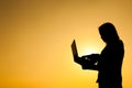 Business woman holding laptop sunset silhouette Royalty Free Stock Photo