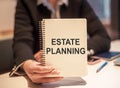 Business woman holding a notebook with the text: Estate Planning