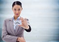 Business woman holding out card showing idea doodles against blurry blue wood panel Royalty Free Stock Photo