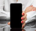 Business woman holding phone in hands, howing to you a blank phone screen Royalty Free Stock Photo