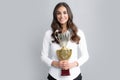 Business woman holding a trophy. Businesswoman concept winner success. Smiling female with trophy isolated on gray Royalty Free Stock Photo