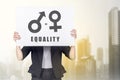 Business woman holding white banner with equality of gender symbol