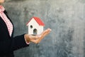 Business woman holding white little house on hand Royalty Free Stock Photo