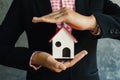 Business woman holding white little house on hand Royalty Free Stock Photo