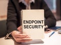 Business woman holds a notebook with the text Endpoint Security