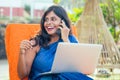 Business woman india asian female freelancer sitting in cafe. woman in indian blue stylish saree sari working on laptop Royalty Free Stock Photo