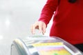 Woman hand insert ticket to ticket entrance train station