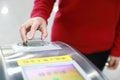 Woman hand traffic card insert ticket to ticket entrance train station