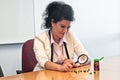 Business woman inspect medicine with magnifier