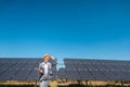 Business woman or investor inspecting her solar farm