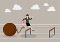 Business woman jumping over hurdle with the weight Royalty Free Stock Photo