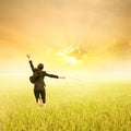 Business woman jumping in Yellow Rice fields and sunset on success day Royalty Free Stock Photo