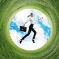 Business woman jumps in rotated field with green grass. Royalty Free Stock Photo