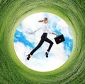 Business woman jumps in rotated field with green grass. Royalty Free Stock Photo