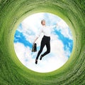 Business woman jumps in rotated field with green grass. Royalty Free Stock Photo