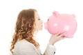 Business woman kissing a piggybank.