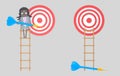 Business woman on ladder holding a blue dart. Dartboard. Isolated.