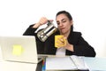 Business woman at laptop computer desk drinking coffee excited and anxious in caffeine addiction Royalty Free Stock Photo