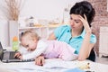 Business woman with laptop and her baby girl Royalty Free Stock Photo