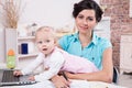 Business woman with laptop and her baby girl Royalty Free Stock Photo