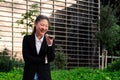 business woman laughing talking by phone in a park Royalty Free Stock Photo