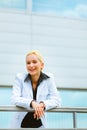 Business woman leaning on railing at office Royalty Free Stock Photo