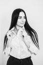 business woman with long brunette hair in white shirt and black skirt on grey background Royalty Free Stock Photo