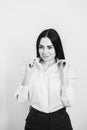 business woman with long brunette hair in white shirt and black skirt on grey background Royalty Free Stock Photo