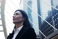 Business woman look up sky and offices building in the city. Royalty Free Stock Photo