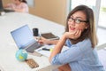 Business woman is looking at camera and smiling while working in office Royalty Free Stock Photo