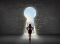 Business woman looking at keyhole with bright cityscape concept Royalty Free Stock Photo