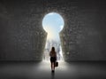 Business woman looking at keyhole with bright cityscape concept Royalty Free Stock Photo