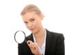 Business woman looking into a magnifying glass Royalty Free Stock Photo