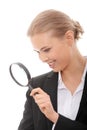 Business woman looking into a magnifying glass Royalty Free Stock Photo