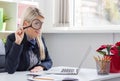 Business woman looking through a magnifying glass while sitting Royalty Free Stock Photo