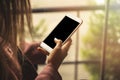 Business woman looking on smart phone in a cafe, Close up of female hands holding cell telephone with screen Royalty Free Stock Photo