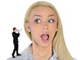 Business woman looking surprised on little man Royalty Free Stock Photo