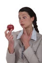 Businesswoman looking at an apple. Royalty Free Stock Photo