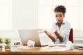 Business woman at a loss working on laptop at office