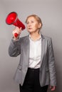 Business woman making announcement with megaphone or loudspeaker Royalty Free Stock Photo