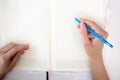 Business woman making notes in notepad. Beautiful well-groomed hands close-up hands, holding a pen Royalty Free Stock Photo