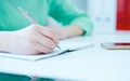 Business woman making notes with pen at office workplace. Royalty Free Stock Photo