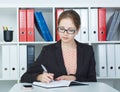 Business woman making notes at office workplace. Royalty Free Stock Photo