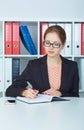 Business woman in glasses making notes at office workplace. Business job offer, financial success, certified public Royalty Free Stock Photo