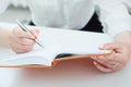 Business woman making notes in the phonebook close-up at office workplace. Business job offer, financial success Royalty Free Stock Photo