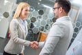 Business woman and man shaking hands after successful meeting in office. Royalty Free Stock Photo