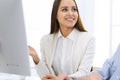 Business woman and man sitting and working with computer in office. Colleagues discussing something at meeting Royalty Free Stock Photo