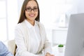 Business woman and man sitting and working with computer in office. Colleagues discussing something at meeting Royalty Free Stock Photo