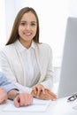 Business woman and man sitting and working with computer in office. Colleagues discussing something at meeting Royalty Free Stock Photo