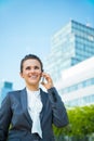 Business woman in modern office district talking cellphone Royalty Free Stock Photo